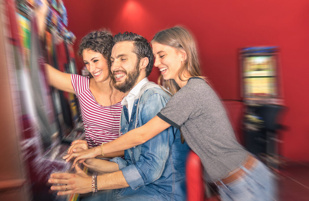 A group of young professionals at a slot machine