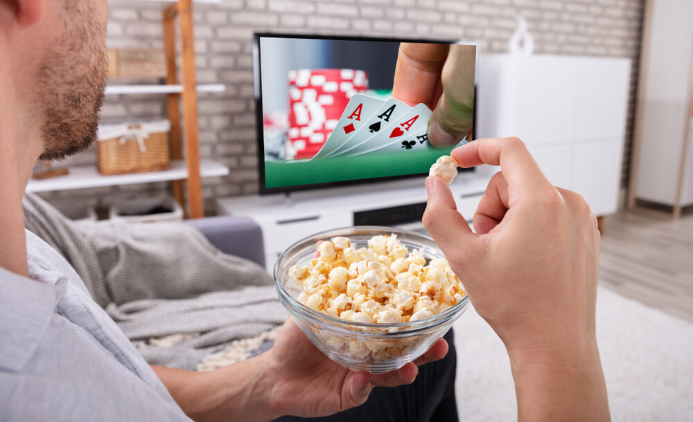 A man watching a casino film on TV