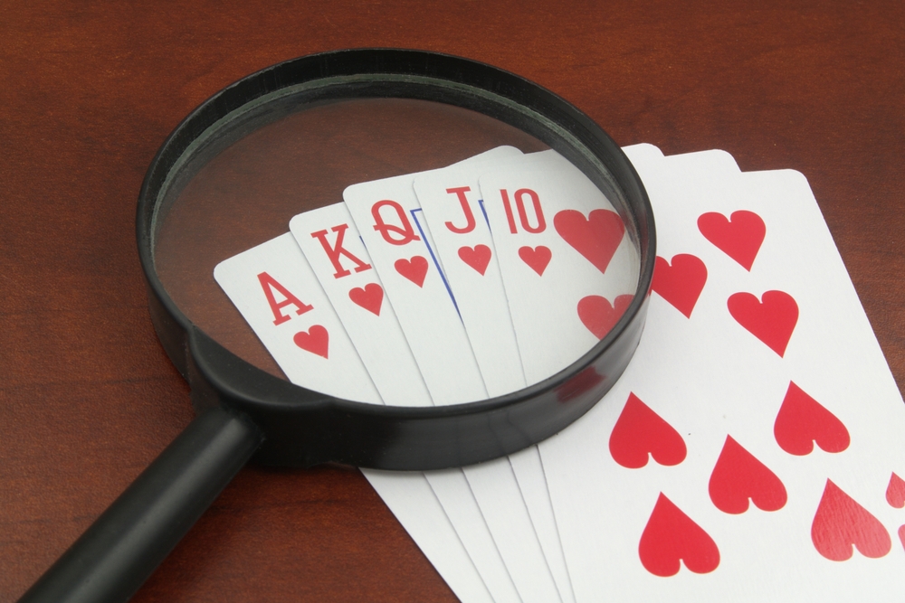 Hearts royal flush, and magnifying glass